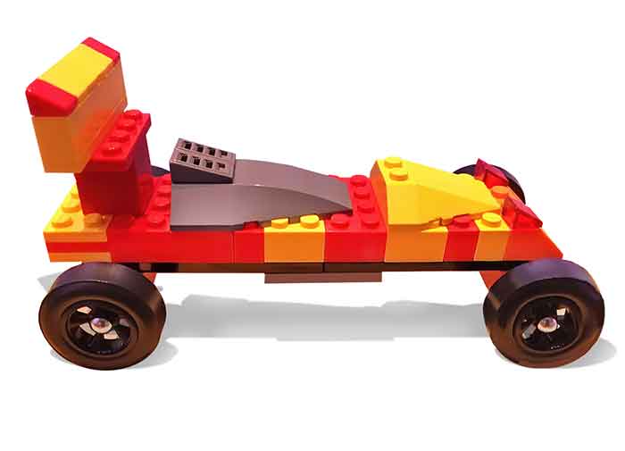 Gray cockpit on a red and yellow LEGO pinewood derby car 